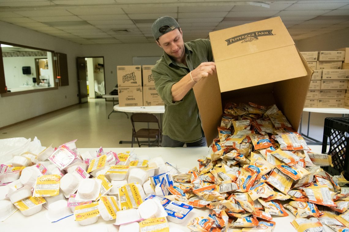 Campus Kitchen Coordinator Ryan Brink prepares to make snack packs for the Backpack Program.