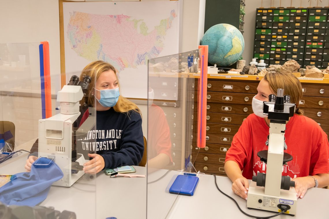 Students stay healthy in Geology Professor Lisa Greer&#039;s class by using their own microscopes, staying masked and sitting between plexiglass dividers.