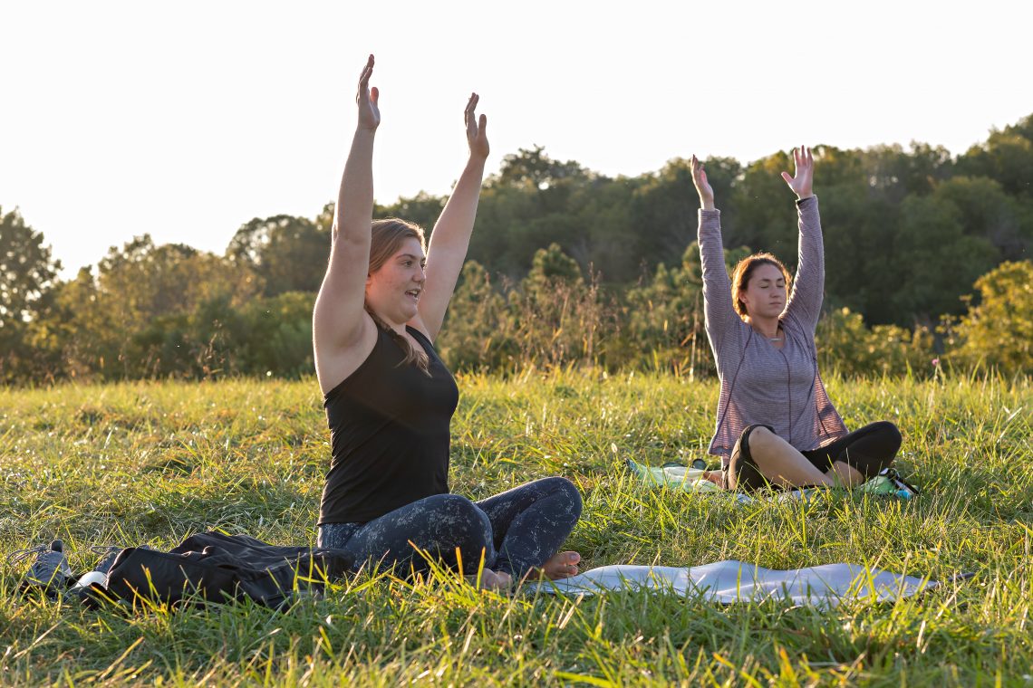 Emmie McElroy &#039;23 instructs a socially distanced sunset yoga class. At right is Frances McIntosh &#039;22.