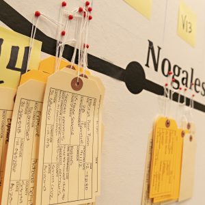 Toe tags bearing details of people who died crossing the border between the U.S. and Mexico hang on a map in Leyburn Library as part of the new exhibit Hostile Terrain 94.