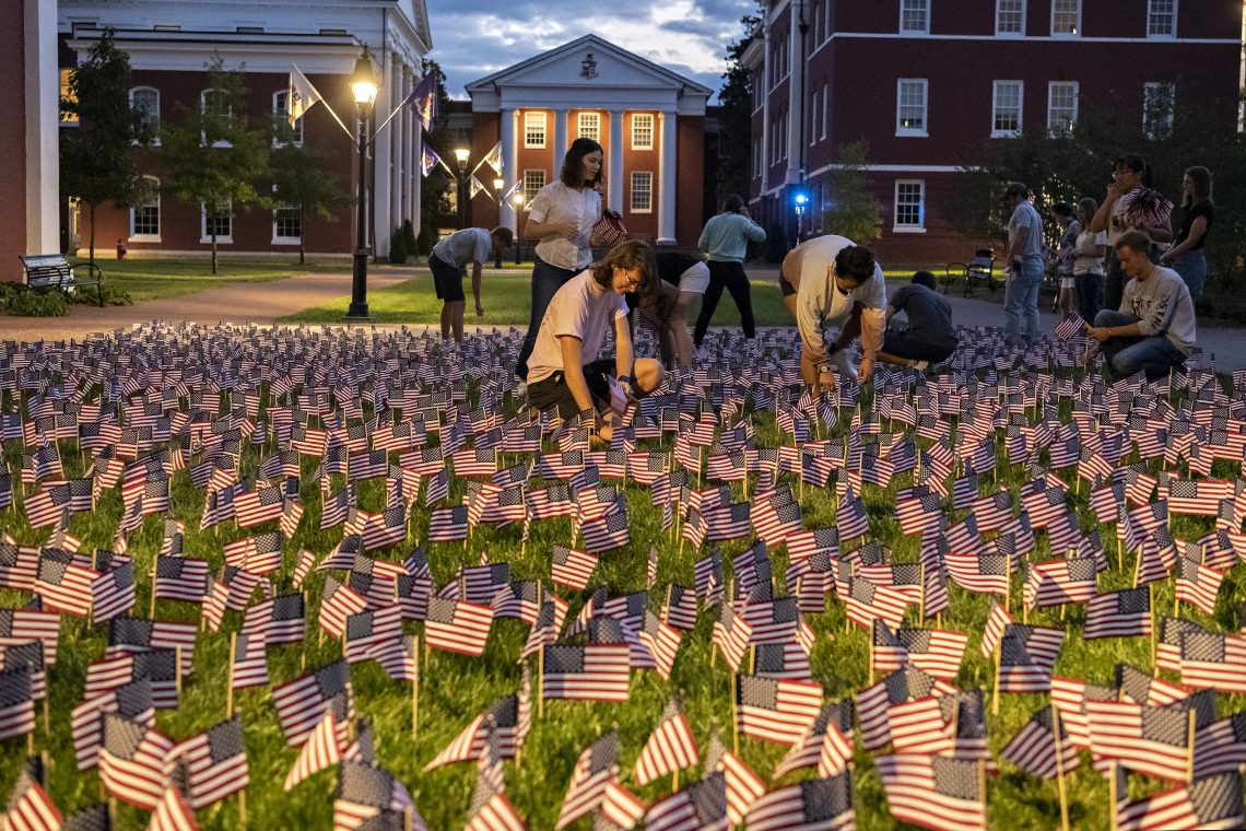 Students put out flags along Stemmons Plaza in memory of the 2,997 people who died on 9/11.
