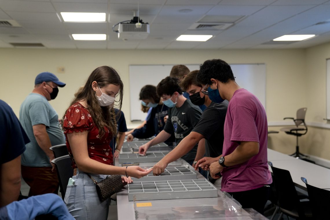 Students look through artifacts discovered during previous digs on the W&amp;L campus.