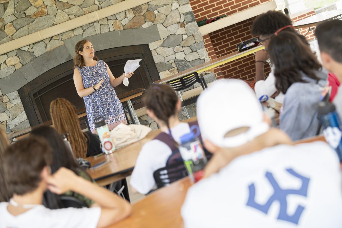 Shiri Yadlin ‘12 speaks to the 2021 Volunteer Venture group on the Law Pavilion.