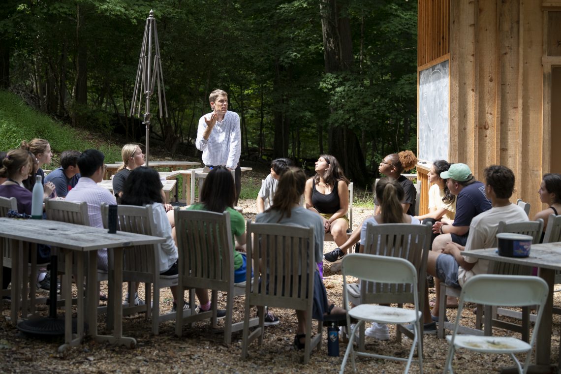 Director of the Shepherd Program Howard Pickett talks to Volunteer Venture participants in an outdoor classroom on campus.