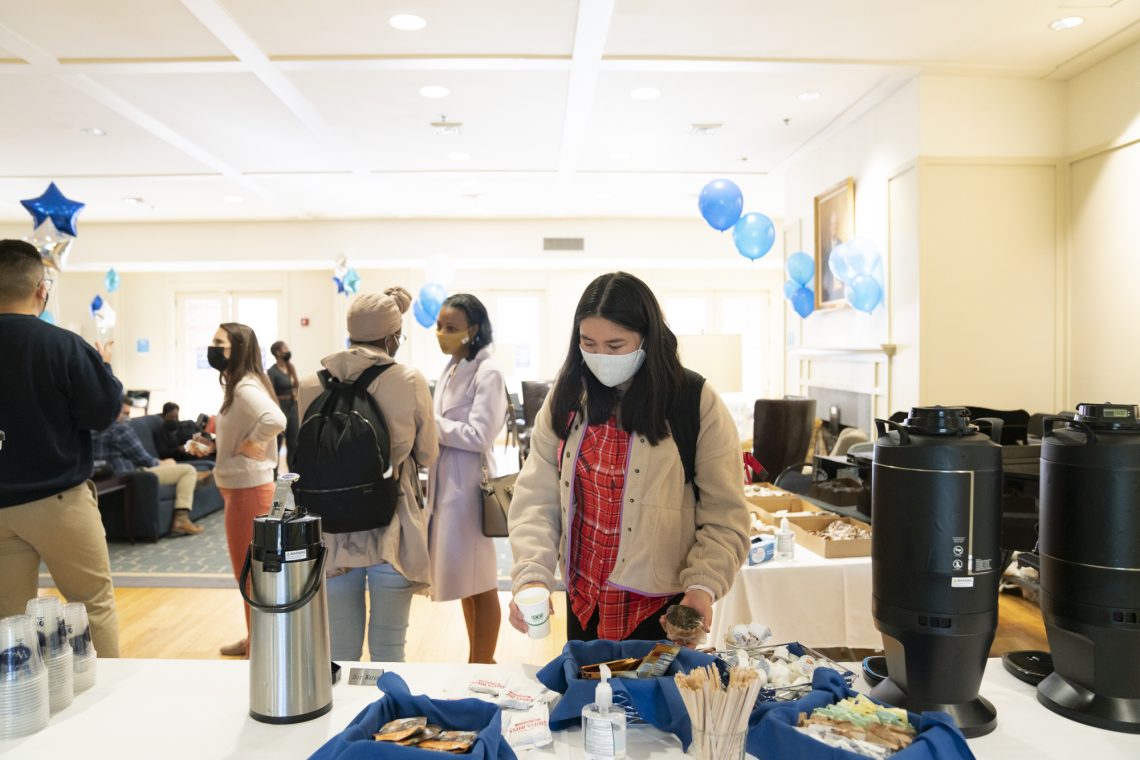 A student grabs a hot drink at the treat table set up by Dining Services at the first-generation student celebration in Elrod Commons.