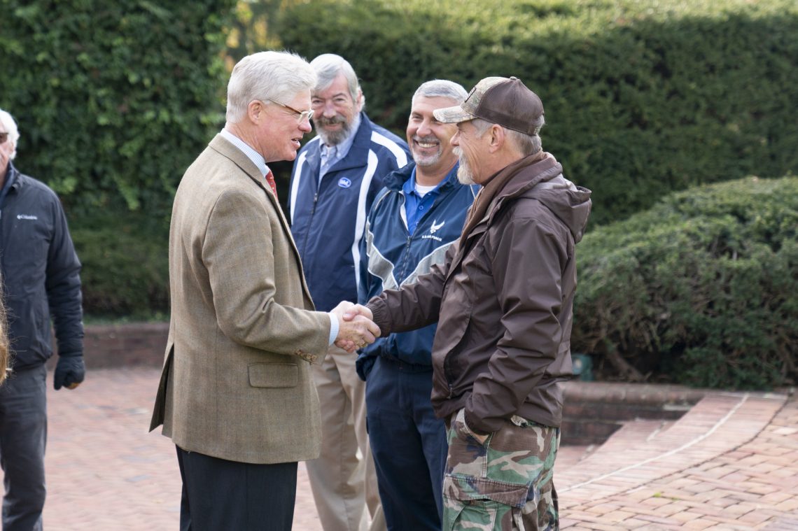 University secretary Jim Farrar greets Daniel Rexrode.