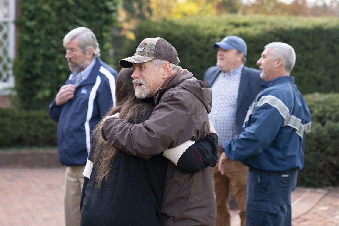 Retired public safety officer Daniel Rexrode shares a hug with 3L Ainsley Satterwhite.