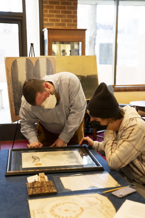 Senior Library Assistant Byron Faidley looks over an historic document with a history student from Powhatan High School.