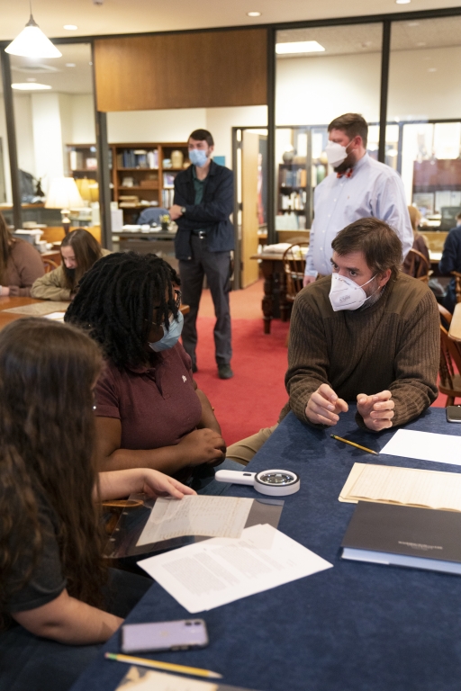 Seth McCormick-Goodhart, assistant director of W&amp;L Special Collections, works with high school students who visited for a day-long workshop.
