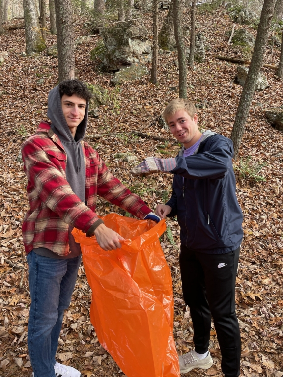 Mens track and field team picking up litter
