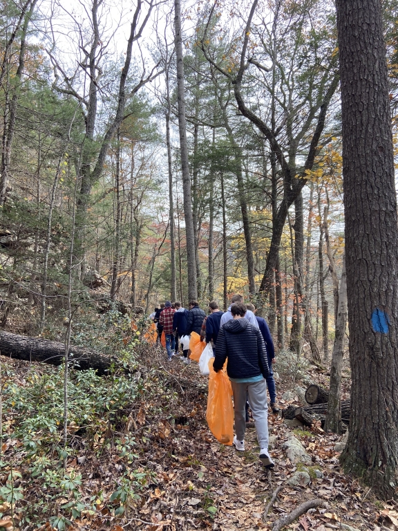 Mens track and field team picking up litter