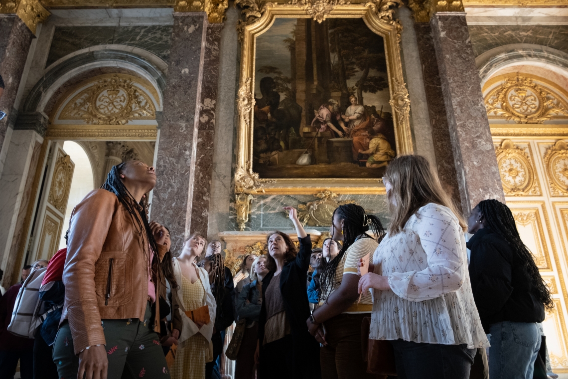 Provost Lena Hill leading a group discussion inside the Palace of Versailles.
