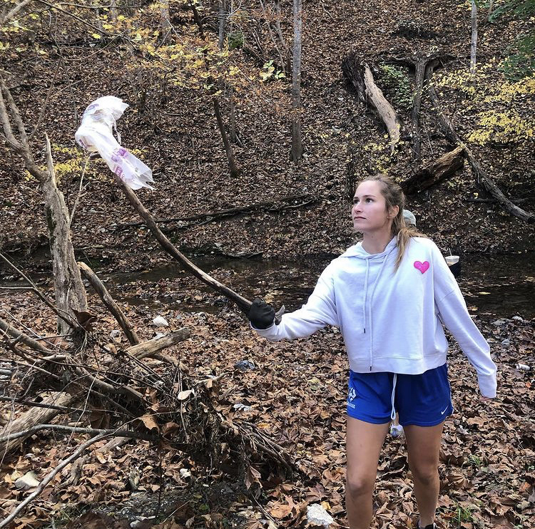Womens lacrosse team picking up litter