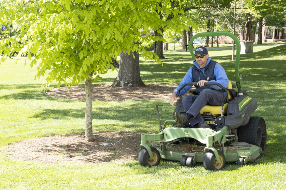 Grounds Worker Keith Moore keeps the Front Lawn looking neat for Commencement.