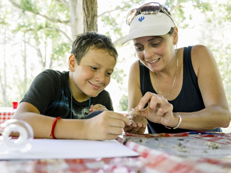 A program assistant from W&amp;L works with a Programa SOL participant on an activity at Boxerwood Nature Center.