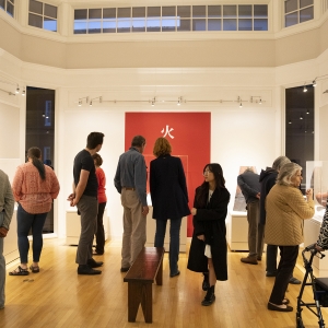 Visitors mingle during Born of Fire opening reception