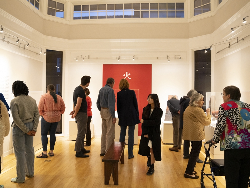 Visitors mingle during Born of Fire opening reception