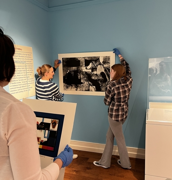 Students talk through the curatorial process with Patricia Hobbs.