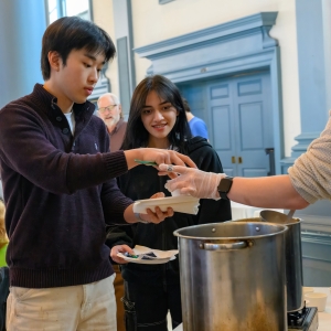 Lex Thompson ’27 serves soup to two Lexington community members at the Souper Bowl in Evans Dining Hall.
