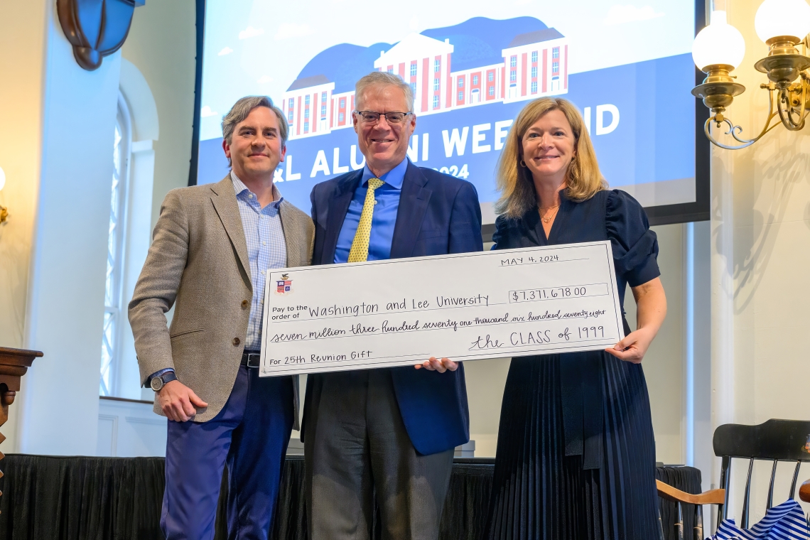 Class of 1999 25th Co-Chairs T. Blair and Cory Mettee Birdsall present the record-setting 25th reunion gift to President Will Dudley during the Alumni Weekend Generals Assembly.