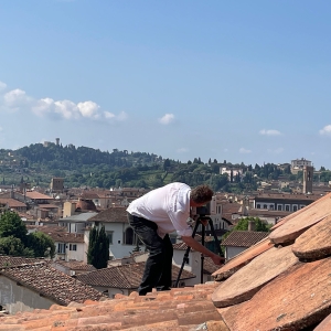 George Bent sets up a scanner on the roof of a building in Florence.