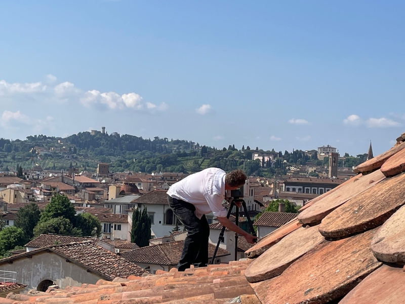 George Bent sets up a scanner on the roof of a building in Florence.