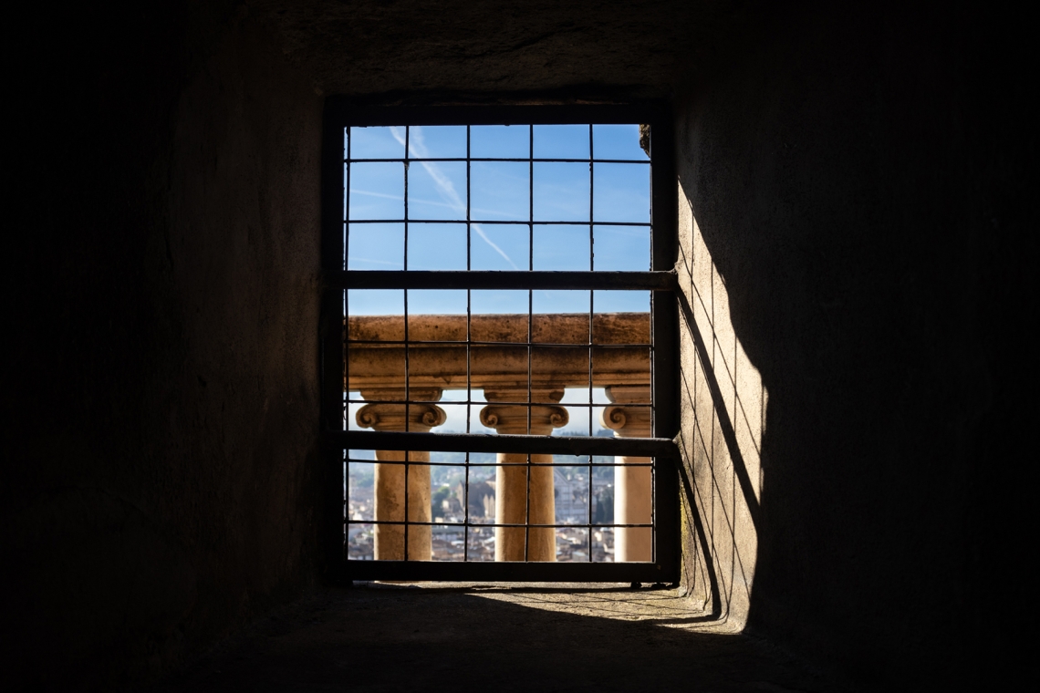 A window near a spiraling staircase that leads to the top of Brunelleschi&#039;s Dome in Florence, Italy.