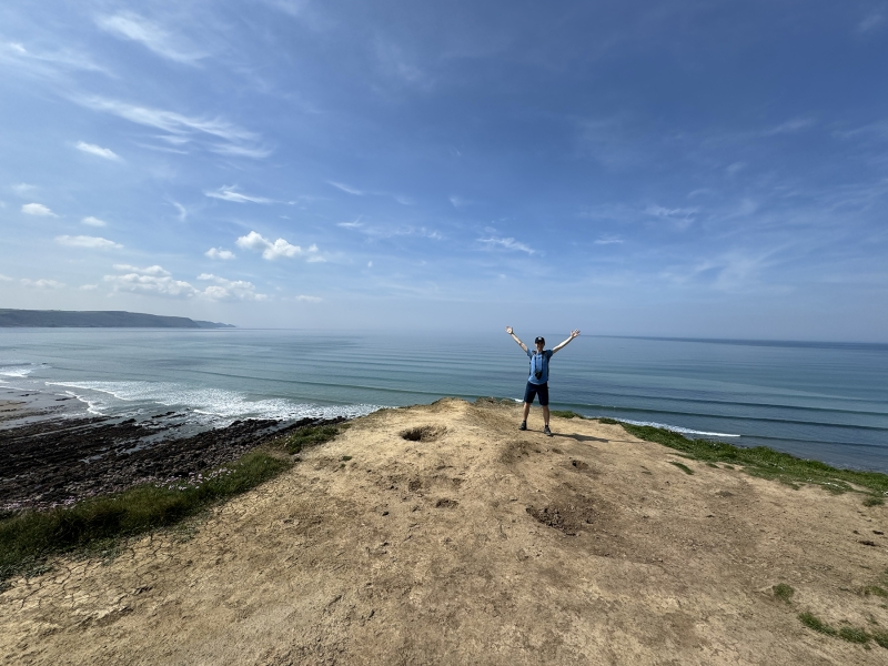 Ryan Doty &#039;26 standing on an overlook just outside of Widemouth Bay, in Cornwall, England