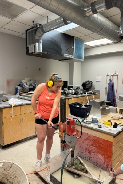 Emma_using_core_machine_in_rock_prep_room-scaled-400x600 Unearthing Answers