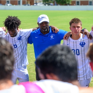 Head Men&#039;s Soccer Coach Lumumba Shabazz talks to the team before their first match of the year.