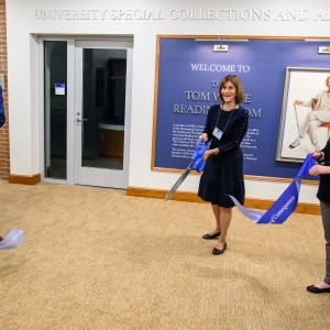 Sheila Wolfe cuts the ribbon to open the new Tom Wolfe Reading Room in Special Collections and Archives, alongside Tad Van Leer '77 and Kim Sims, associate professor and associate university librarian for Special Collections and Archives.