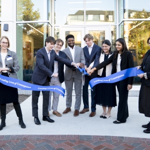 Student leaders cut the ribbon at the dedication ceremony for the new building for the Williams School of Commerce, Economics and Politics.