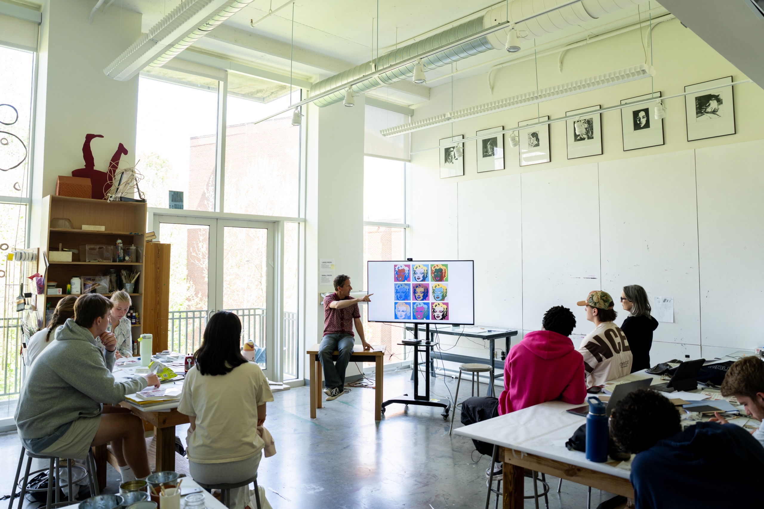 Students in the Creating Comics class discuss abstract comics and work on an assignment.