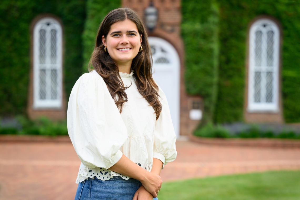 A photo of Reagan Reiferson standing in front of University Chapel.