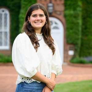 A photo of Reagan Reiferson standing in front of University Chapel.